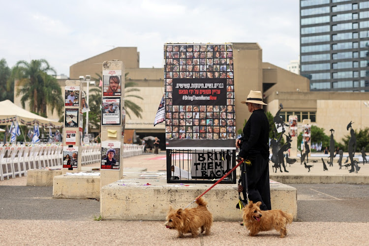 A woman looks at an installation that shows the pictures of hostages taken by Hamas and missing people waiting to come home. Picture: HADAS PARUSH/REUTERS