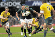 Victor Matfield  fends off a tackle from Adam Ashley- Cooper in the tri-nations test match  between the Springboks and the Wallabies in Durban