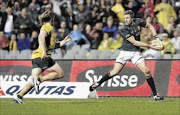 MARKED MAN: Jean de Villiers, right,  has been lauded by friend and foe for his mature game and  leadership skills. Moving in for a tackle here is Australia's Michael Hooper
    
       photo: reuters