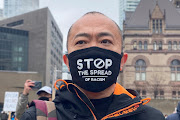 A man attends a protest against anti-Asian hate crimes, racism and vandalism, outside City Hall in Toronto, Ontario, Canada, March 28, 2021.