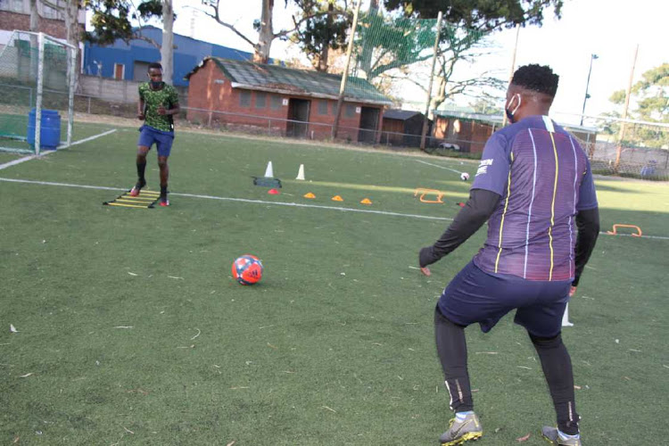 Loyiso Bolsiki, on his back in navy shots, helps aspiring young footballers reach their potential when he trains them individually to keep fit during the lockdown regulations.