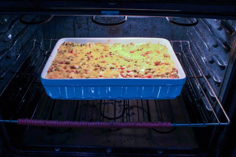 Cheddar Cheese Sprinkled On Top Of The Casserole.