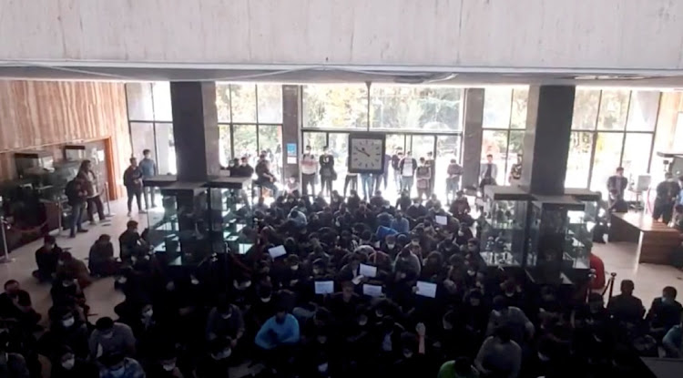 Protesters chant at a vigil for Mahsa Amini, the woman who died in police custody last month, at the entrance hall of the Khajeh Nasir Toosi University of Technology in Tehran, Iran October 26 2022 in this screengrab from social media video. Picture: REUTERS ATTENTION EDITORS - THIS IMAGE HAS BEEN SUPPLIED BY A THIRD PARTY. NO RESALES. NO ARCHIVES.