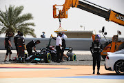 Lewis Hamilton of Great Britain and Mercedes GP makes his way to the race control car after stopping on track during day two of testing at Bahrain International Circuit on March 13 2021.