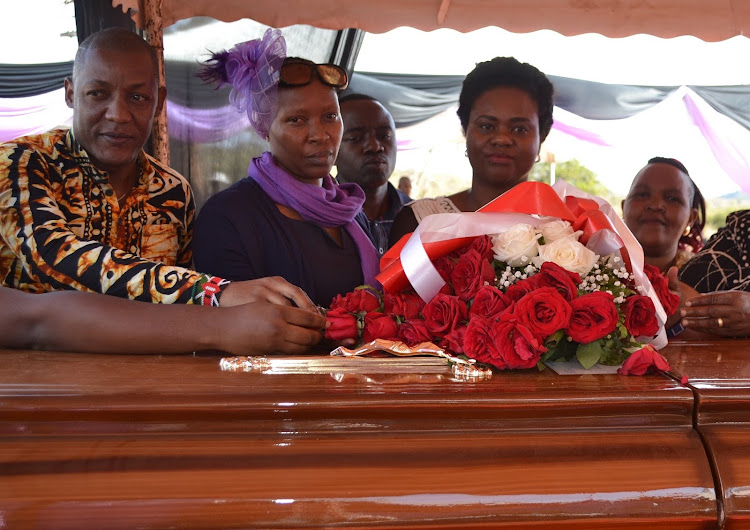 Kitui Woman Representative Irene Kasalu (R) with Kitui County NGAAF coordinator Lydia Kavete and Kasalu’s personal assistant Ben Kilonzo with Rev. Joshua Kasovo casket during his burial at Kathumbini village in Mwingi North on Saturday, July 21, 2019