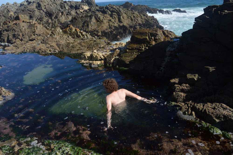 Enjoying an early morning dip in a rock pool in front of the oceanettes