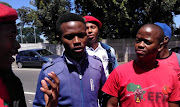 EFF student leader Aseza Mayaphi, middle, outside the Bellville Magistrate's Court following his appearance for possession of state property on January 24 2019 