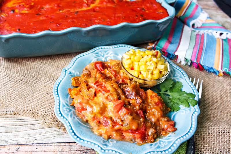 Taco Crunch Casserole On A Plate With Corn.