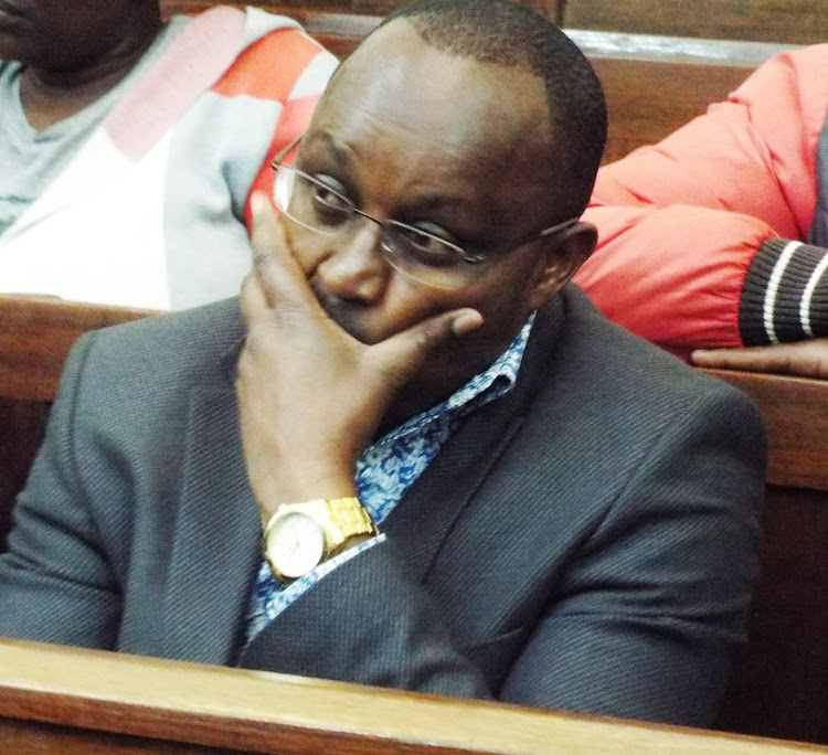 President Ruto's press secretary Emmanuel Tallam during a past hearing of the murder case in which three suspects are charged with killing his father.