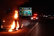 Firefighters try to put out a VW Kombi that caught fire soon after the newly married couple driving it left their wedding reception in Johannesburg on Saturday night.