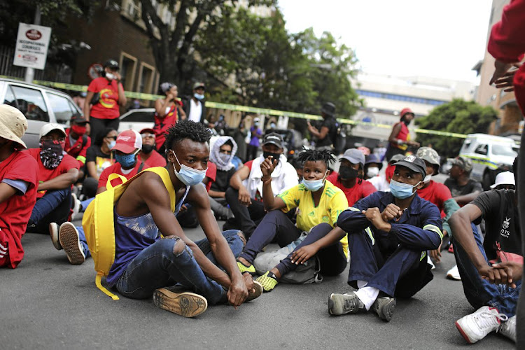 Students gather in the street to honour the memory of Mthokozisi Ntumba who was killed when police used force to disperse student protesters outside the Wits University campus in Braamfontein, Johannesburg. The protests were sparked by government plans to cut back on student funding.