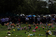 People stand as the casket of Amerie Jo Garza, one of the victims of the Robb Elementary school mass shooting that resulted in the deaths of 19 children and two teachers, is carried gravesite Hillcrest Memorial Cemetery in Uvalde, Texas, US, May 31, 2022. 