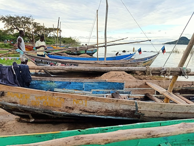 Fishermen next to their boats at Lake Victoria. Fishing is still the main source of income but catches have been dramatically reduced over the years due to overfishing and pollution.