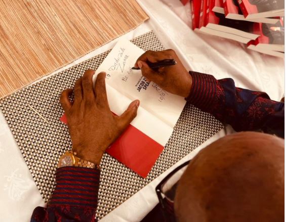 Former-president Jacob Zuma signs his autobiography ahead of his book launch on Sunday.