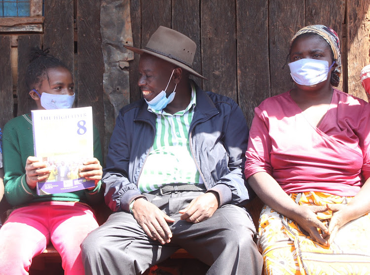 Abigail Wanjiku from Kiriko Primary School, Mathira MP Rigathi Gachagua and Wanjiku’s mother Maureen Nyokabi after the MP delivered the revision book at their home in Kaiyaba area in Mathira on Monday