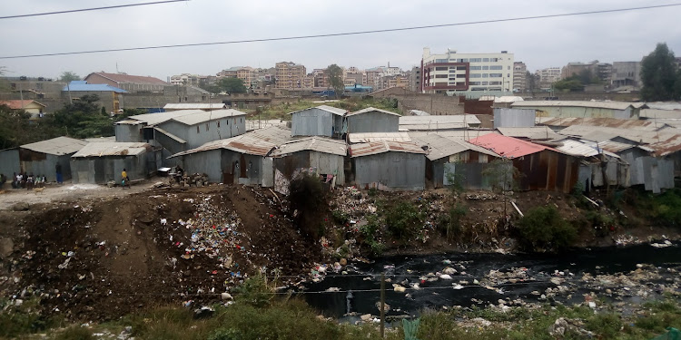 Houses to be demolished in Tassia on riparian land. They dump garbage and discharge raw sewage into the Nairobi River