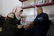 Salam Mahmoud, a volunteer at the Syria Civil Defence (White Helmets), checks the blood pressure of a man, at a White Helmets centre, in Idlib province, Syria March 5, 2023.