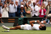 Carlos Alcaraz of Spain celebrates winning championship point of the men's singles final against Novak Djokovic of Serbia on day 14 of The Championships Wimbledon 2023 at the All England Lawn Tennis and Croquet Club on July 16 2023.