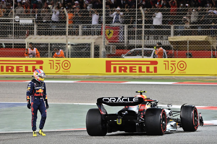 Sergio Perez looks at his car after retiring from the race during the F1 Grand Prix of Bahrain at Bahrain International Circuit on March 20 2022.