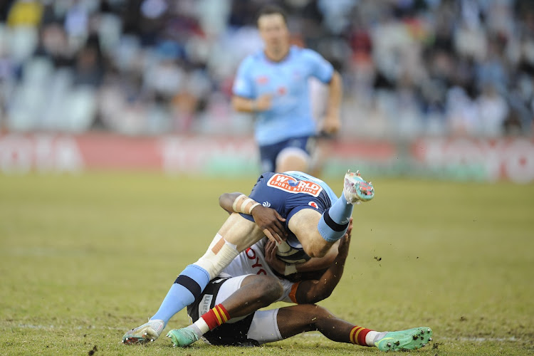 Johan Goosen of the Blue Bulls is tackled during the Currie Cup Premier Division semifinal match against the Cheetahs at Free State Stadium in Bloemfontein on June 17 2023.