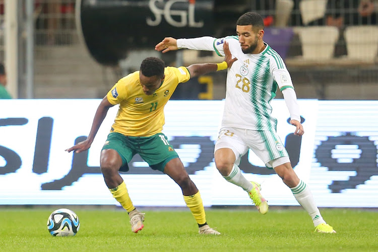 Bafana Bafana's Themba Zwane holds off Ahmed Kendouci of Algeria in the Fifa Series international friendly at Stade Nelson Mandela in Algiers on Tuesday night.