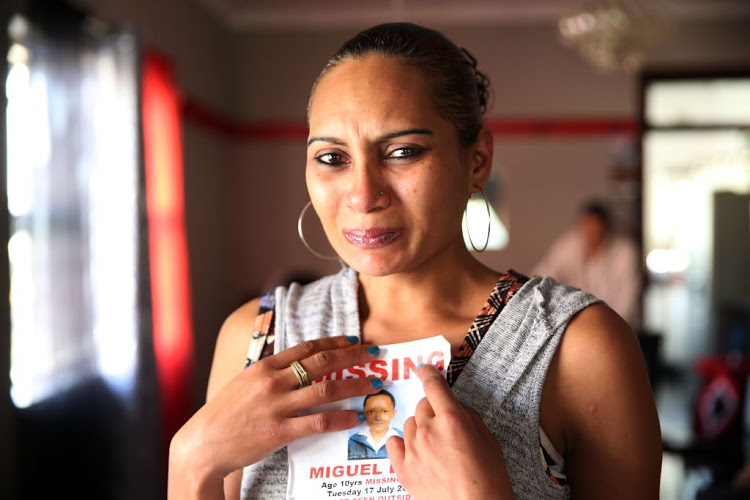 Raylene Louw holds a photo of her missing son, Miguel Louw, in Durban on July 25, 2018.