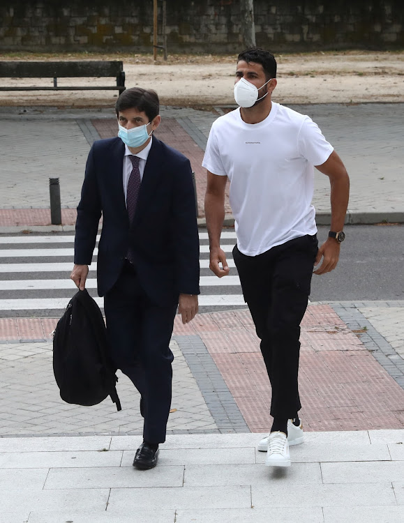 Atletico Madrid's Diego Costa wearing a protective face mask arrives at a court to attend a trial for tax fraud in Madrid, Spain