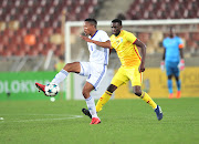 Sera Motebang of Lesotho challenged by Kelvin Moyo (R) of Zimbabwe during the 2018 COSAFA cup semifinals match between Lesotho and Zimbabwe at Peter Mokaba Stadium, Polokwane on 06 June 2018. 
