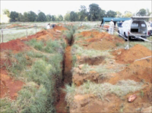 OLD GRAVES: Archaeologist Anton Pelser and forensic experts piecing together evidence of the skeletons found in Robertsville between New Canada and Main Reef roads. 13/04/09. Pic. Penwell Dlamini. © Sowetan.