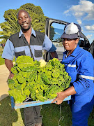 Tim Abaa and Thuli Mthethwa in Orange Farm with some of the produce they donated to needy families.
