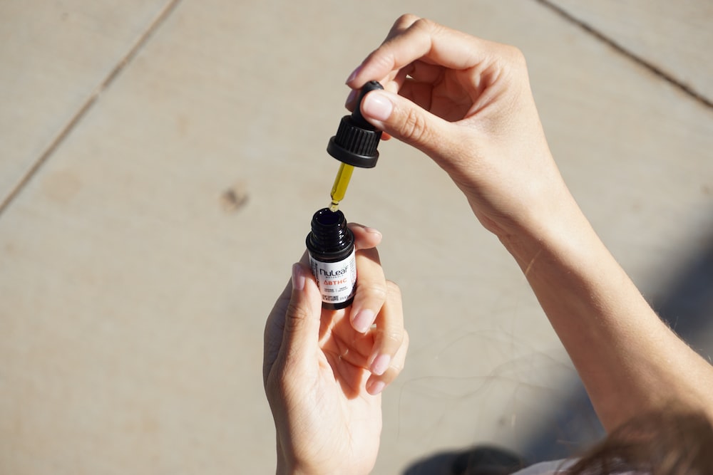 person holding black and white bottle