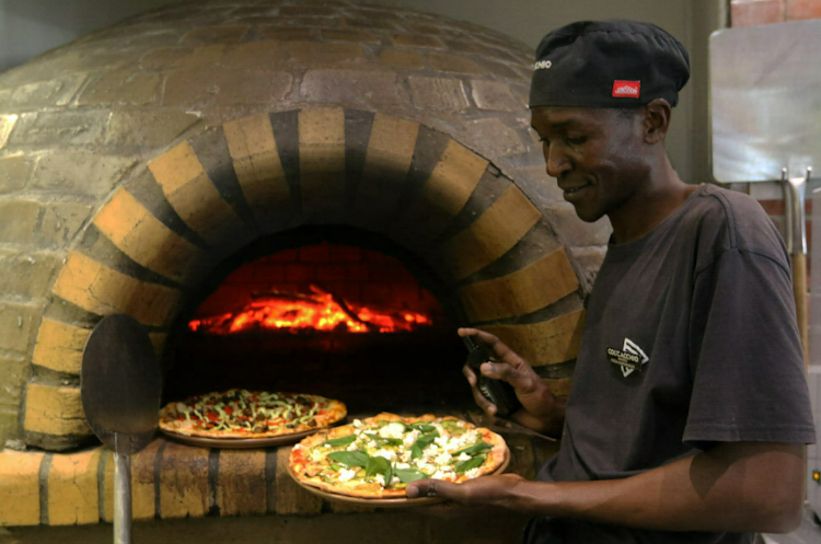 The Boardwalk’s Col’Cacchio restaurant chef Nkosinathi Mokoena with two cannabis pizzas