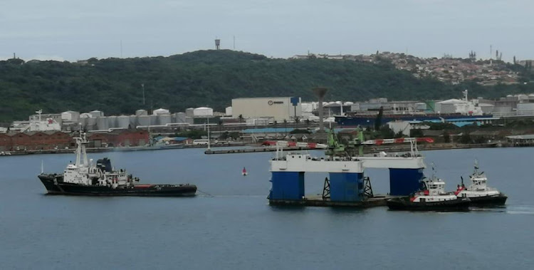 The floating dry dock leaves Durban harbour with the SA Amandla on Friday.