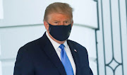 US President Donald Trump wearing a protective face mask as he departs the White House to fly to Walter Reed National Military Medical Center, where it was announced he will work for at least several days after testing positive for Covid-19 on October 2 2020.