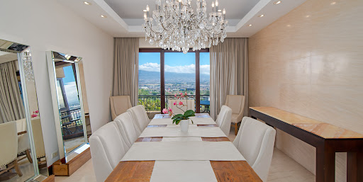 Dining room with panoramic city view in this luxury apartment / penthouse for sale in Escazú ($1,280,000 - 483 m²)