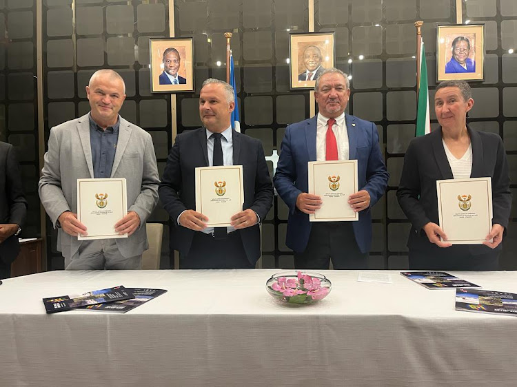 Sascoc president Barry Hendricks, second from right, and the representatives of Montpellier, Sète and Millau holding copies of their co-operation agreements at the South African embassy in France.