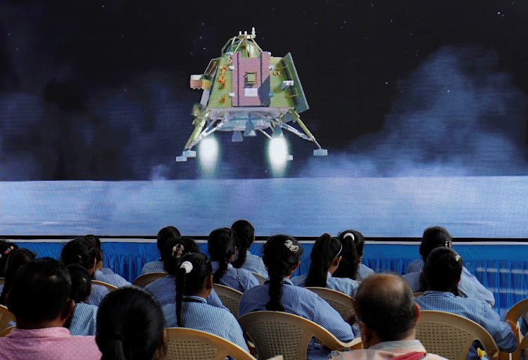 People watch a livestream of Chandrayaan-3 spacecraft's landing on the moon, inside an auditorium of Gujarat Science City in Ahmedabad, India, August 23 2023. Picture: AMIT DAVE/REUTERS