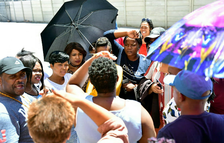 Unhappy M Secure security guards gather outside the Daku Hall in Kwazakhele