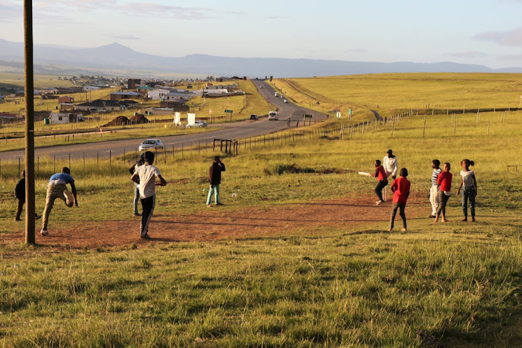 Children play cricket as if it's business as usual in rural areas.