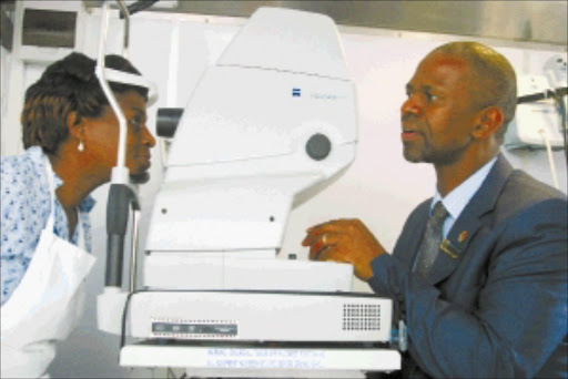 A GODSEND:Mercedes-Benz South Africa employee Lindiwe BIYELA WITH KwaZulu-Natal mec FOR HEALTH Sibongiseni DHLOMO in the mobile eye care clinic. Pic: THEMBA MNGOMEZULU. 18/02/2010. © Unknown.