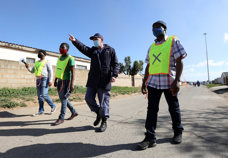 Zwide Heights Neighbourhood watch members and SAPS, from left, Thulani Cumgcanywango, Fundile Sokutu, Captain Andre Beetge and Milile Nkoloti walk the streets of Zwide wearing new bibs on Monday