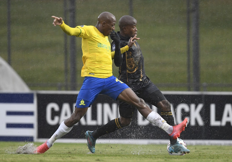 Thabo Matlaba of Royal AM is challenged by Khuliso Mudau of Mamelodi Sundowns during their DStv Premiership match at Chatsworth Stadium.