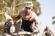 Nino Schurter grabs a bottle during stage four of the Absa Cape Epic Mountain Bike stage race around CPUT, Wellington, on Thursday