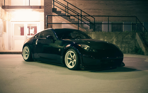 Shiny Car Parked Beside a Brick Building screenshot 1