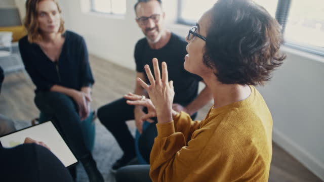 three workers sitting down and discussing a project