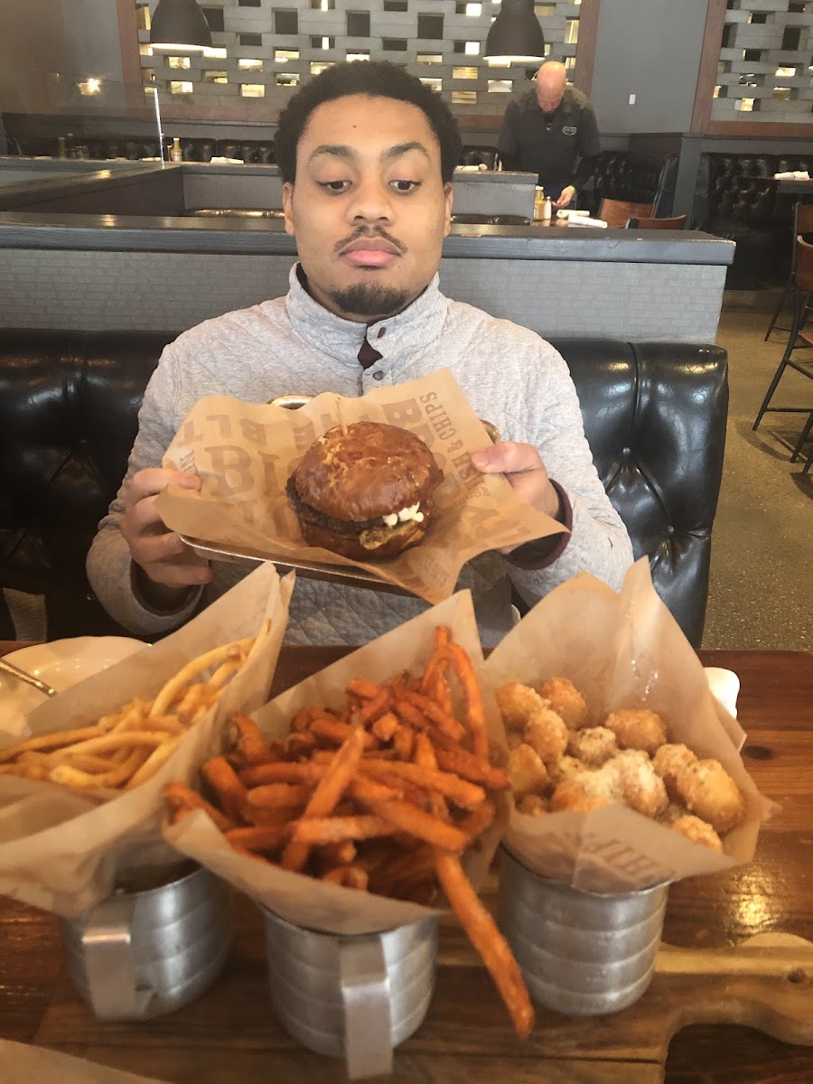 My husband posing with all my GF goodies! Highly recommend the truffle tots