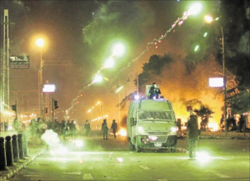 MASS ANGER: A protester throws a teargas canister fired by security forces toward riot police during clashes outside the Egyptian presidential palace in the suburb of Heliopolis in Cairo at the weekend. Photo: Getty Images