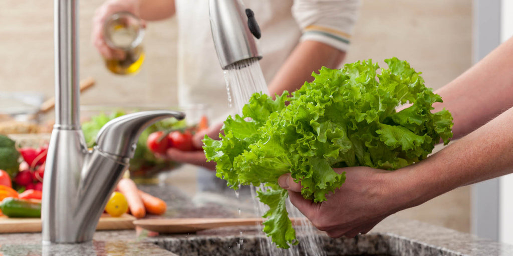 Person washing veggies with the Clearly Filtered Under Sink System