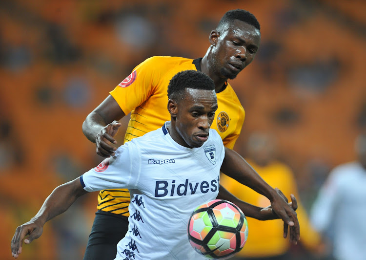 Mxolisi Macuphu of Bidvest Wits shields the ball from Kaizer Chiefs centre back Eric Mathoho during an Absa Premiership match at FNB Stadium on August 7, 2018.