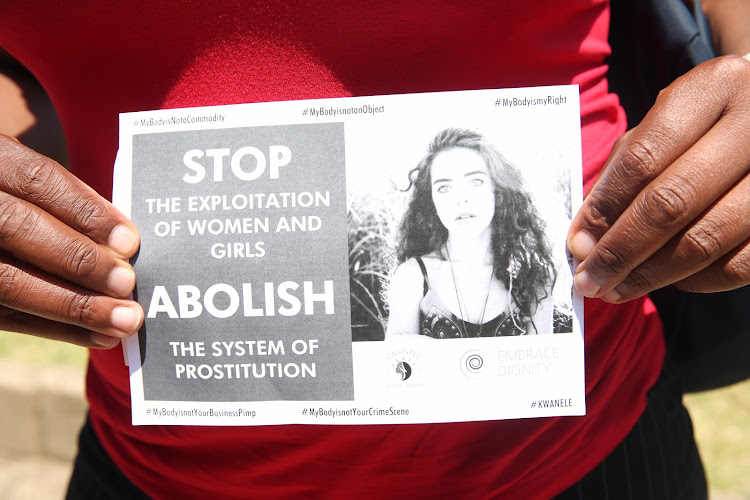 Women show support for slain escort Siam Lee outside the Durban Magistrate's Court on Wednesday, where the man accused of her murder appeared. In the weeks before her death the 20-year-old had reached out to sex-worker support groups to help her escape her double life.